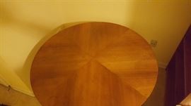 wood dinner table with brass accents on feet