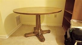 wood dinner table with brass accents on feet