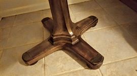 wood dinner table with brass accents on feet