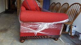 red couch, navy blue piping on cushions, wood feet and detailing