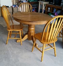 oak dinner table and leaf. note the base & 1 leg needs repair. chairs sold separately.