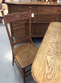 Look at this pressed back caned chair