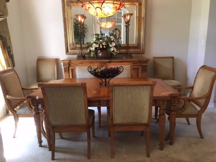Carved wood dining table with inlays, extension leaf and 8 chairs with upholstered backs and seats (2 are armchairs), also matching buffet behind on wall (see other photos of that and table leg details)