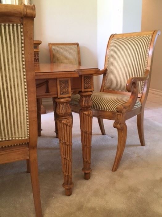 Carved wood dining table and chair detail