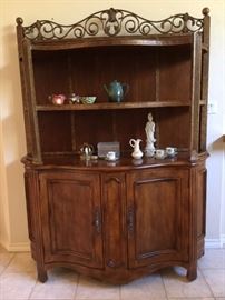 Large wood and metal display cabinet with 3 tiered shelves and bow front base with double doors and shelves inside 