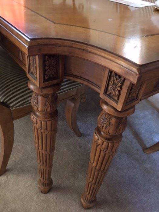 Carved wood dining table leg detail