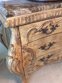 Detail of large carved wood vanity dresser with marble top