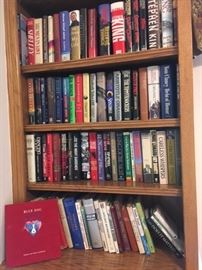 Two bookshelves of hardcover books