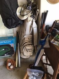 Golf clubs, ball return in box, golf travel bag, small baseball glove, bat, balls and softball bat