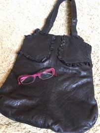 Oversized Italian black leather bag by Lucky, and a vintage pair of "Guapa" reading glasses by Face a Face. 