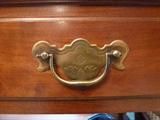 Detail on the drawer pull of the side table of the dining room set.