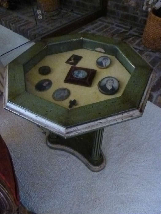 Vintage table with glass top and memorabilia encased in glass.