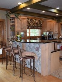 Everything in this photo is for sale including the stone, window treatments, cupboards and granite counter tops.