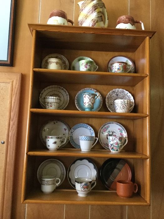 Cup and saucer sets in wall cabinet