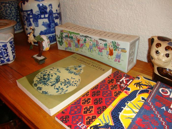 Chinese ceramic pillow, books on Chinese pottery and handwoven rugs