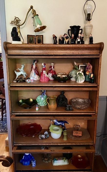 Beautiful barrister bookcase filled with lamps with unique shades, Royal Doulton, including Dickens' characters, carnival glass pieces as well as other glass and china items.
