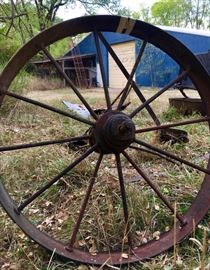 Metal wagon wheel, antique metal shovel, assorted other antique farming hardware
