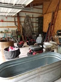 Motorized wheelchair, metal barrels, metal water troughs, shelving units, camouflage, bikes, snowblowers, outboard motors with fuel cans