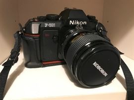 Nikon F-301 camera. Includes case and extra lens.