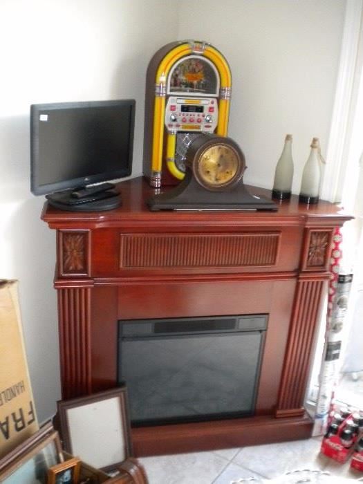 Electric fireplace, monitor cd juke box and clock. 