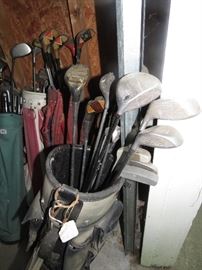 Lots of golf clubs and bags.