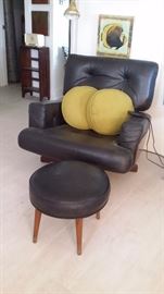 MCM BLACK LEATHER SWIVEL CHAIR with CURVED WOOD BACK & SIDES.....ROUND FOOTSTOOL & BRASS FLOOR LAMP