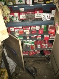 Vintage auto and motorcycle parts still in boxes - several cabinets = look for more photos