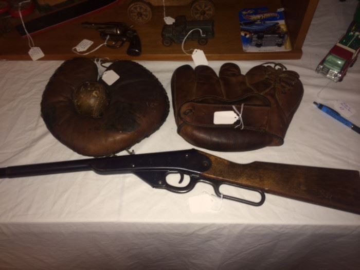 2 very old baseball gloves and an old bb gun