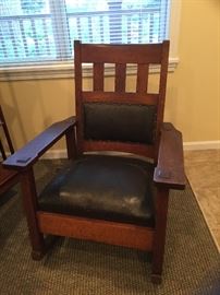 Antique Stickley rocking chair with lumbar cushion. .