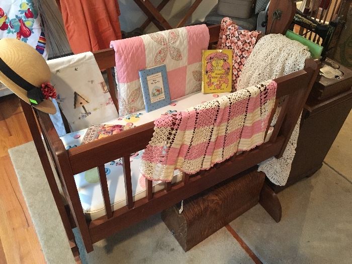 Rocking wooden crib... might not be good for babies, but makes a great display area... or place for you decorative bed pillows at night