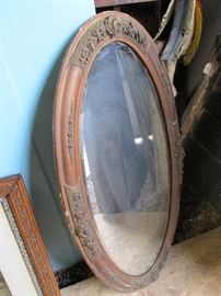 Large oval beveled mirror, raised floral gesso detail