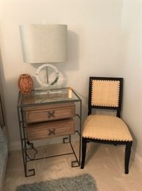 One of two night stands , one of two acrylic lamps, single chair.