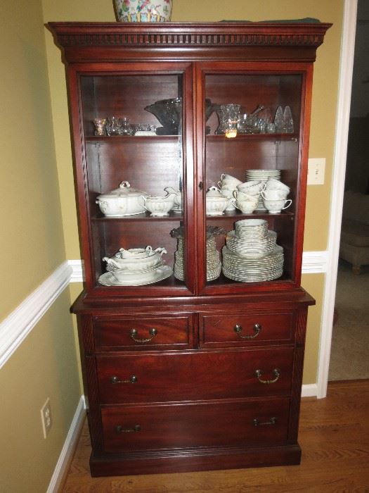 CHINA CABINET WITH LOTS OF CHINA.