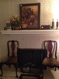 Two of four matching antique chairs with leopard print fabric