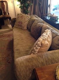 One of two matching gold sofas