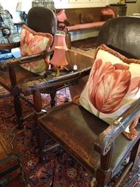 Fine antique pair of leather and loved chairs; colorful accent pillows