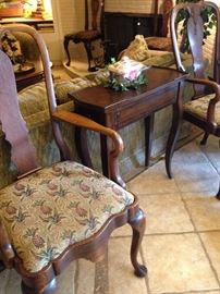 One of two arm chairs with pineapple (sign of hospitality) upholstery; small side table