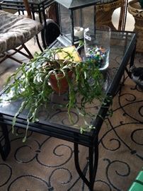 This glass top patio table has two side tables.