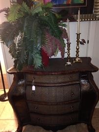 Four drawer Bombay chest; artificial plant; brass candlesticks