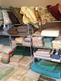 Many towels, placemats, pillows, sheets, etc.