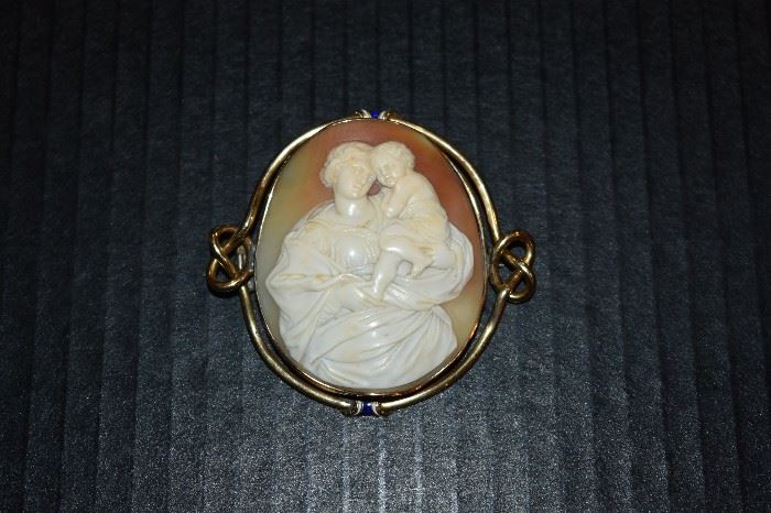 17.) Cameo Pin - One (1) ladies 18kt yellow gold cameo pin measuring approx. 2 3/8" in length by approx. 2" in width and is bezel set in twisted gold mounting which is lead soldered on back. Also has blue and white enamel at top and bottom.
