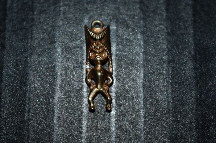 13) One (1) 14kt. yellow gold head dress charm weighing approx. 1,81dwt and measures approx. 1" in length.