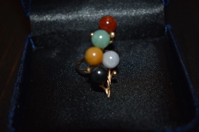 2) Jadite Ring - One ladies 10kt. gold ring mounting weighing approx. 3.69dwt and is set with five (5) round jadite beads each measuring approx. 7mm in diameter and are dyed as follows: one (1) black, one (1) tan, one (1) light green , one (1) burnt orange, and one (1) lavender.