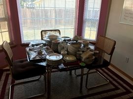 Retro glass table top dining set.  Dishes and cutlery.