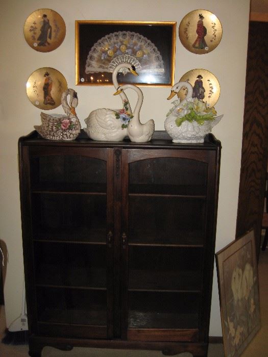 Swans and vintage glass front cabinet