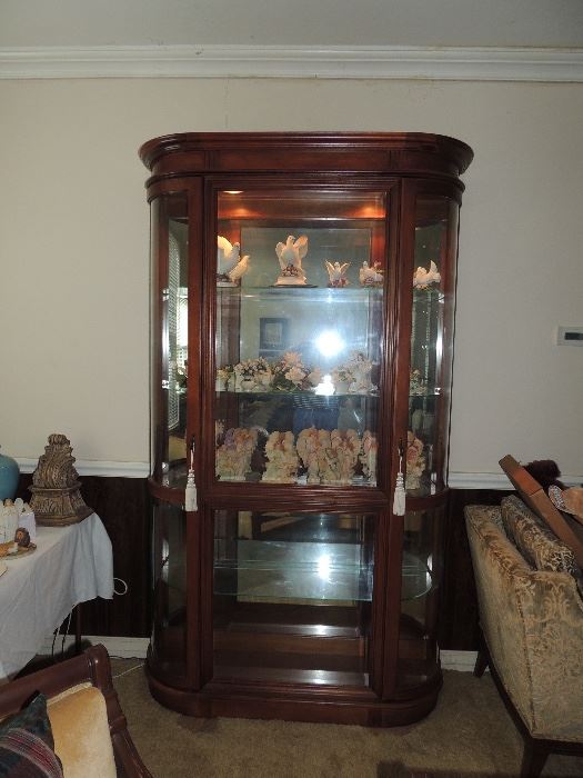 Curio cabinet,  full of pretty decorative  pieces, including Andre figures.