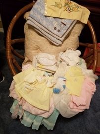 Rattan Chair, vintage baby clothes and blankets