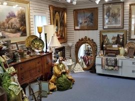 One of the showrooms.  Beautiful antique mahogany sideboard,  one of three wise men, ornate framed beveled mirror, and framed art.