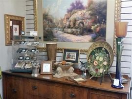 Large framed Thomas Kinkade above the antique sideboard.