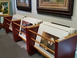 Three of the many rolling racks for displaying unframed art.